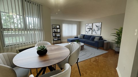 a living room and dining room with a table and chairs